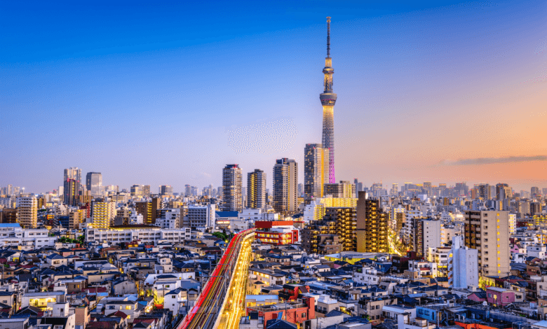 Paisagem urbana de Tóquio ao pôr do sol, com luzes de tráfego em longa exposição e a torre Tokyo Skytree centralizada ao fundo.